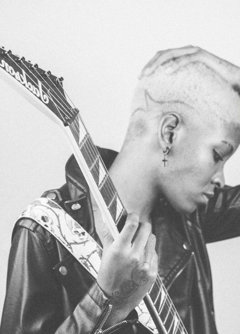 black woman posing with electric guitar