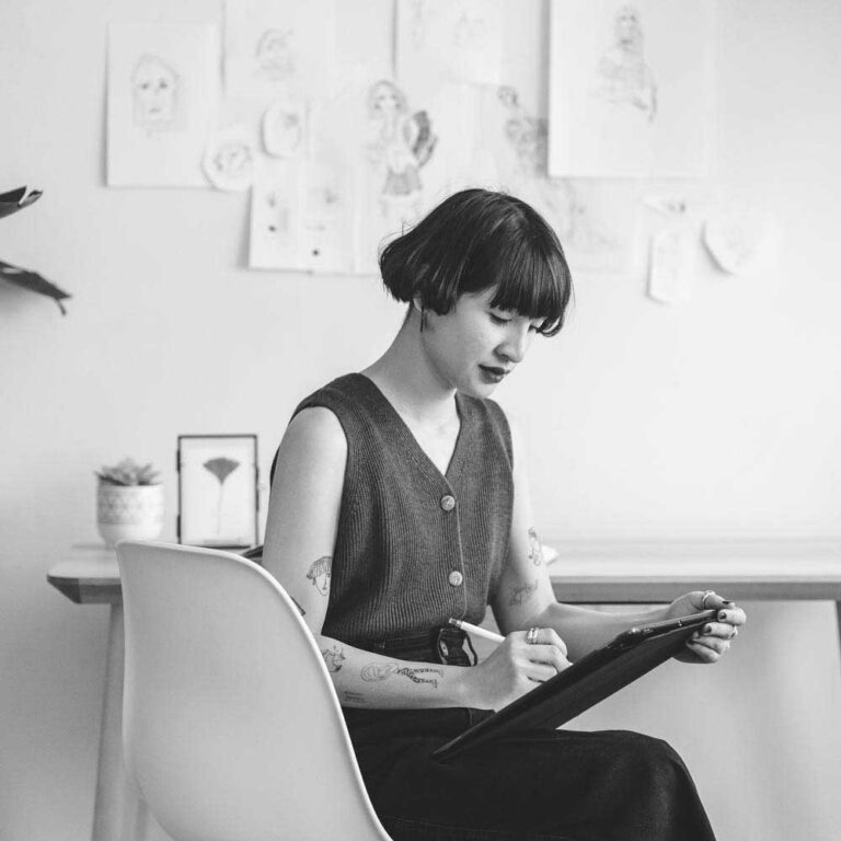 latina artist drawing on ipad