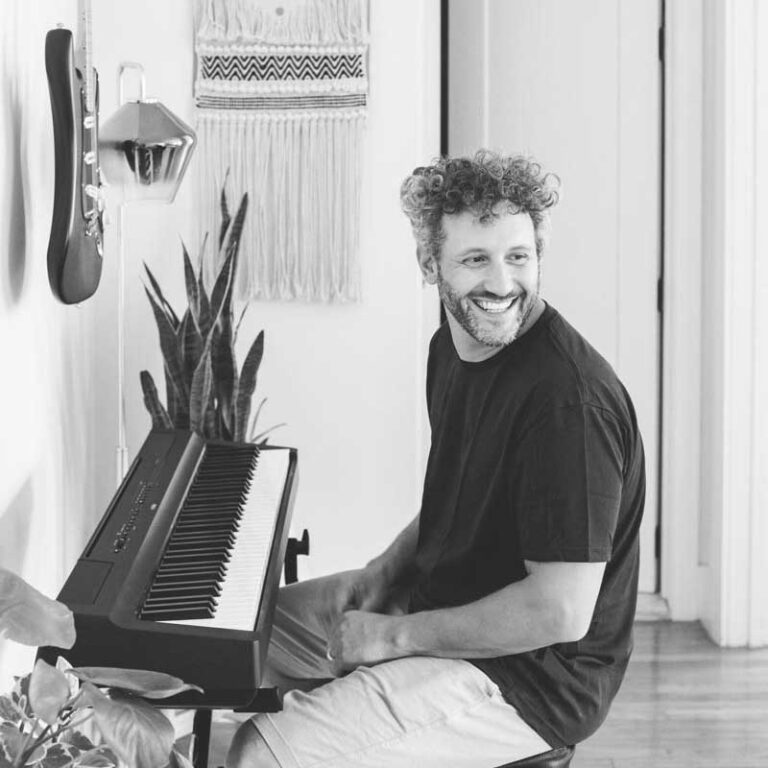 man-smiling-playing-piano