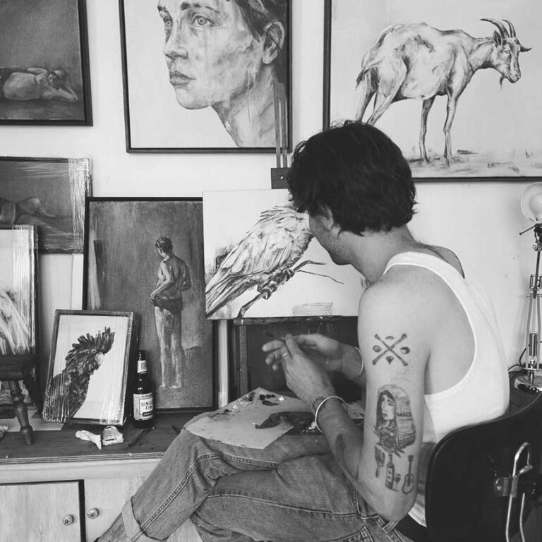 millennial man painting at desk